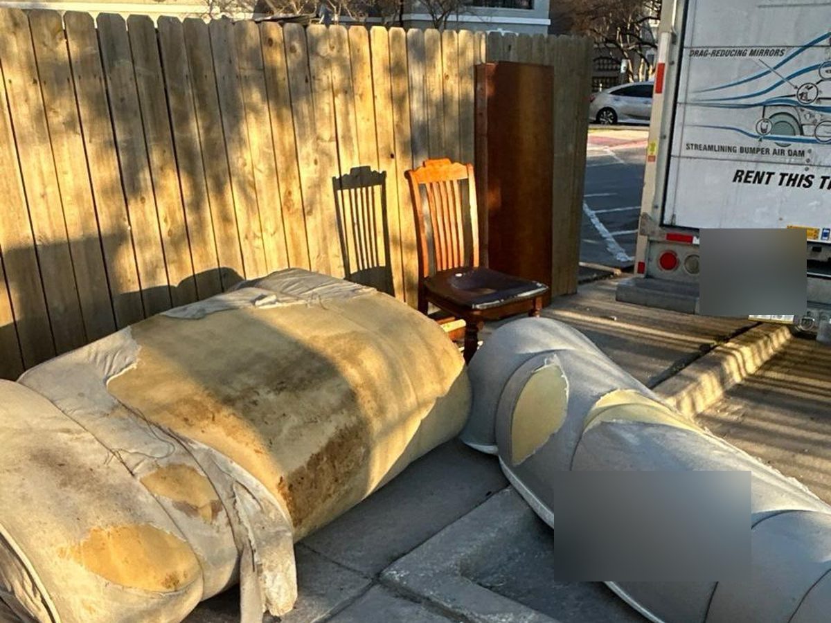 Before bulk furniture removal with couch pieces and chairs by moving truck